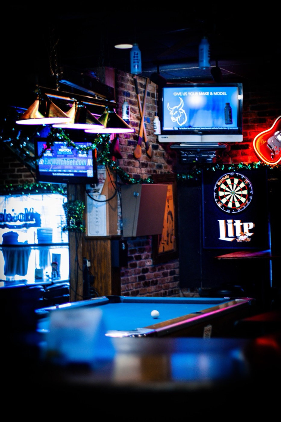 Pool table, dart board and sports TVs inside Fiddler's Green bar in Stamford, CT